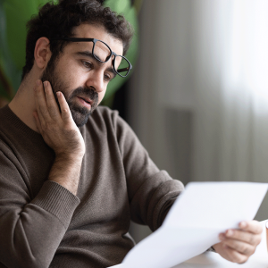 Man looking at letter from HMRC