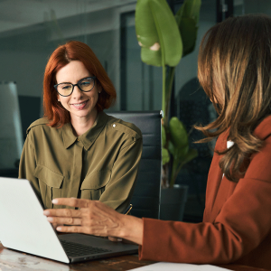 Two women looking at computer screen
